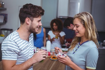 Smiling friends having breakfast 