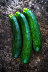 Fresh zucchini on wooden background