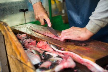 slicing unagi japanese eel fish for sell at Tsukiji seafood market, Japan