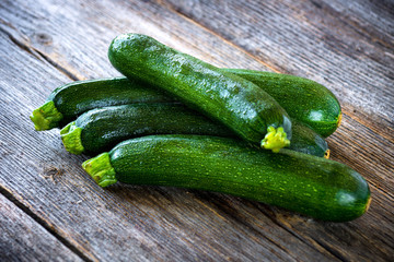 Fresh zucchini on wooden background