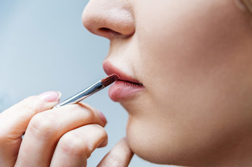 Makeup artist doing makeup for girl