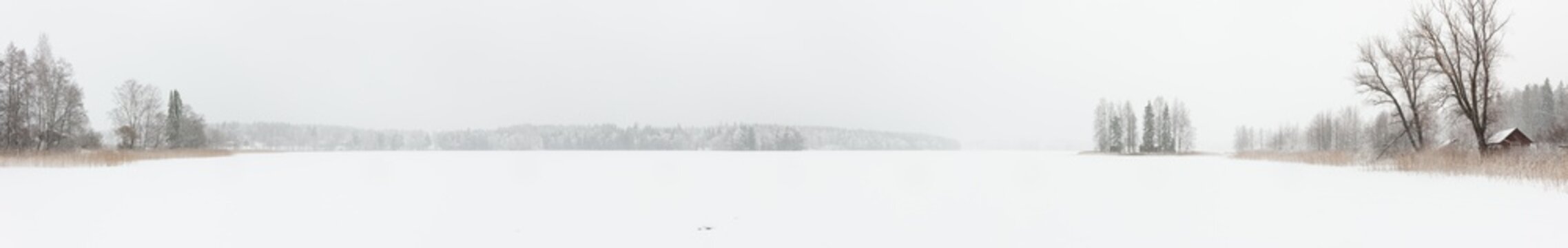 Blizzard winter landscape at frozen lake