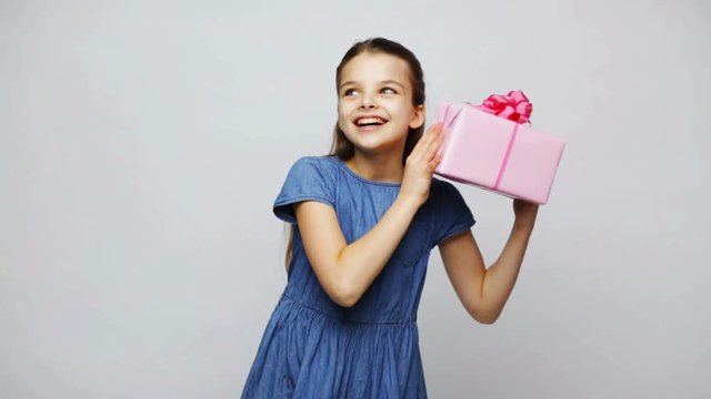 happy smiling girl holding gift box
