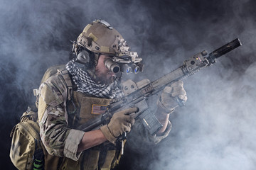 US Army Soldier in Action with goggles in the Smoke - 107931471