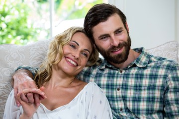Fototapeta premium Thoughtful couple sitting on sofa