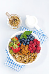 breakfast bowl with fresh berries, granola and almond