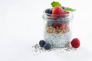 Breakfast in a glass jar, chia with berries and oat flakes