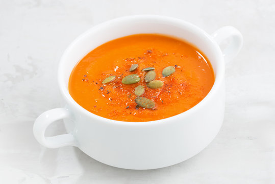 colorful pumpkin cream soup on a white background