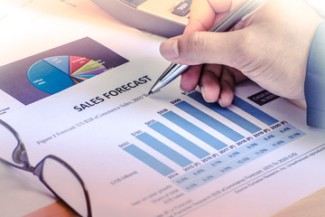Financial accounting sales forecast graphs analysis with hand writing