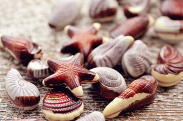Swiss chocolate seashells on wooden background