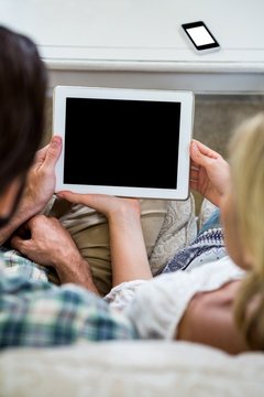 Cropped image of couple with digital tablet at home