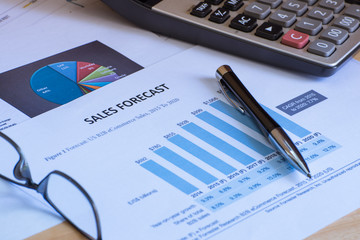 Financial accounting sales forecast graphs analysis with hand writing