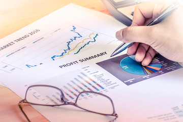 Financial accounting profit summary graphs analysis with hand writing