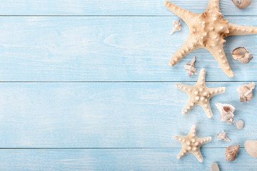 Starfishes and sea shells on wooden background