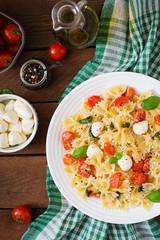 Farfalle Pasta - Caprese salad with tomato, mozzarella and basil. Top view