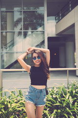 Young lovely girl in denim shorts enjoying her day