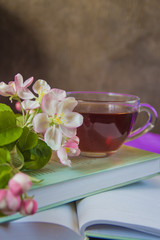 Fototapeta na wymiar Books, flowers and cup of tea.