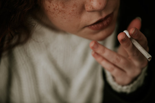 Redhead teen smoking woman in the forest