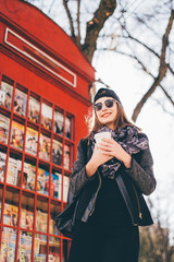 Beautiful girl standing in front of call box