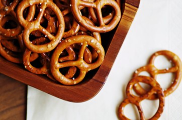 Snack. Snack food. Closeup of snacks. Salted pretzel snacks in wooden bowl.