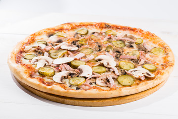 tasty pizza on a white wooden background