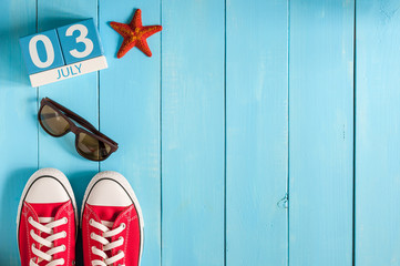 July 3rd. Image of july 3 wooden color calendar on blue background. Summer day. Empty space for text