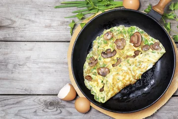 Papier Peint photo Oeufs sur le plat French omelet with herbs, stuffed with mushrooms and onions