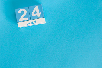 July 24th. Image of july 24 wooden color calendar on blue background. Summer day. Empty space for text