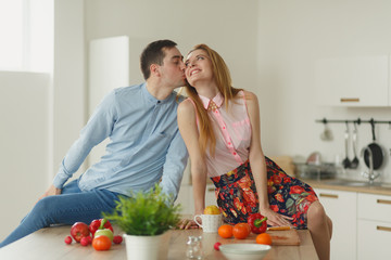 man and woman in the kitchen.