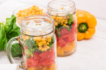 Fototapeta na wymiar Homemade healthy salad in glass jar. Vegetarian concept. Background.