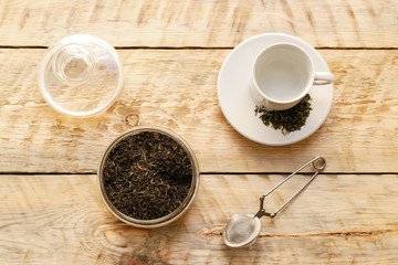 Tea set on the wooden table at sunny morning