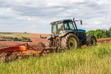 Farmer in tractor working on a field