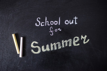 Fototapeta premium The words School's Out written on a chalkboard