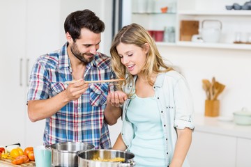 Young couple tasting food