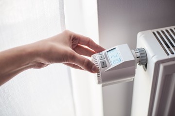 Woman's hand adjusting temperature