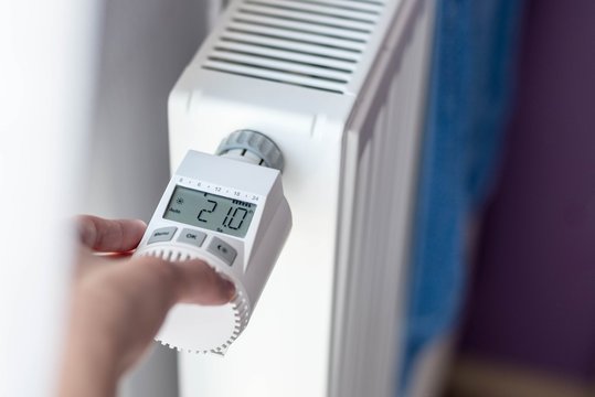 Woman's hand adjusting temperature