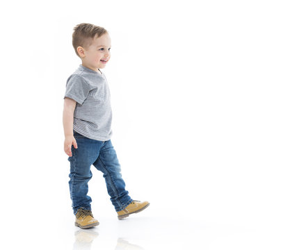 Three Years Boy Eating And Walking Isolated On White