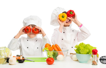 little chefs by table with vegetables