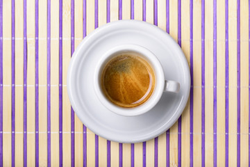 cup of coffee isolated on colored wooden placemat