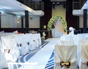 Wedding venue with a bridal bower and chairs
