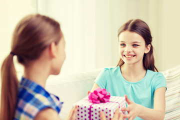 happy little girls with birthday present at home