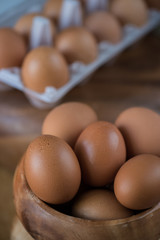 Fresh eggs at wooden plate 