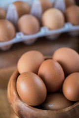 Fresh eggs at wooden plate 
