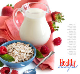 Rolled oats in a bowl with berries and milk