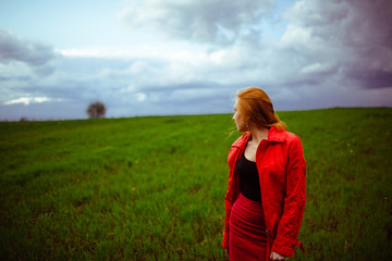 Redhead girl and the cloudy sky