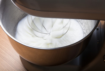 The process of whipping egg whites in a planetary mixer. Selecti