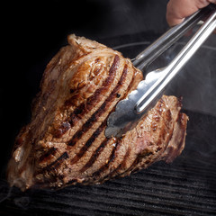 Large piece of fresh beef meat prepared on a grill pan