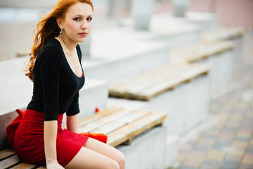 Skinny girl is sitting on the bench