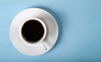 White cup of tea on blue wooden table