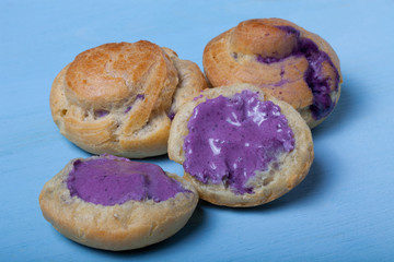 Fresh homemade profiteroles on blue wooden table